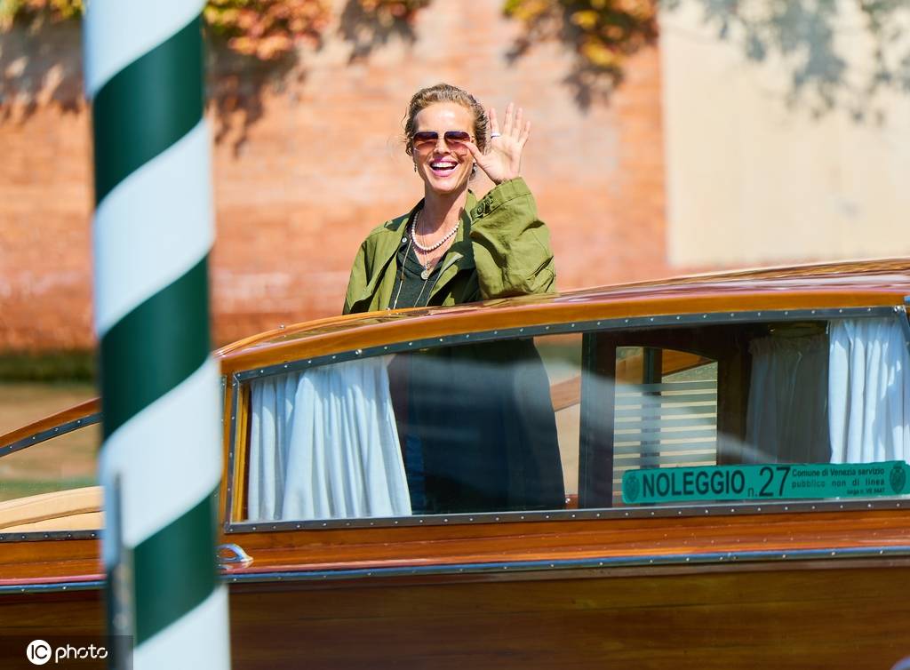 伊娃·赫兹高娃威尼斯电影节期间乘船 身穿绿色风衣对镜头招手
